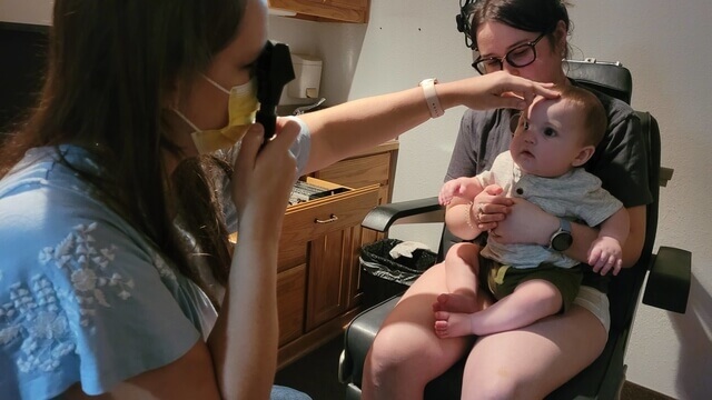 mother with baby at an eye check