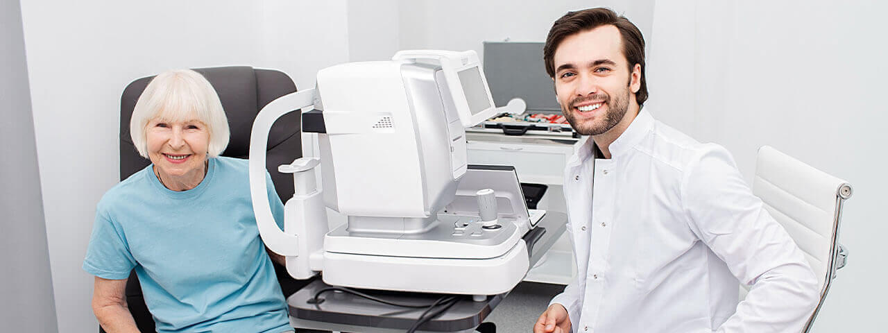 Smiling Optometrist low vision eye exam 1280×480