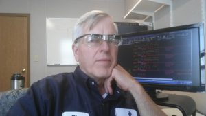 man with low vision glasses at computer