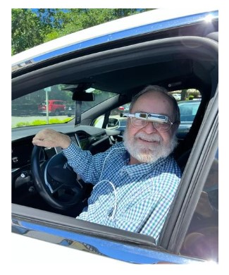 man in car with low vision glasses