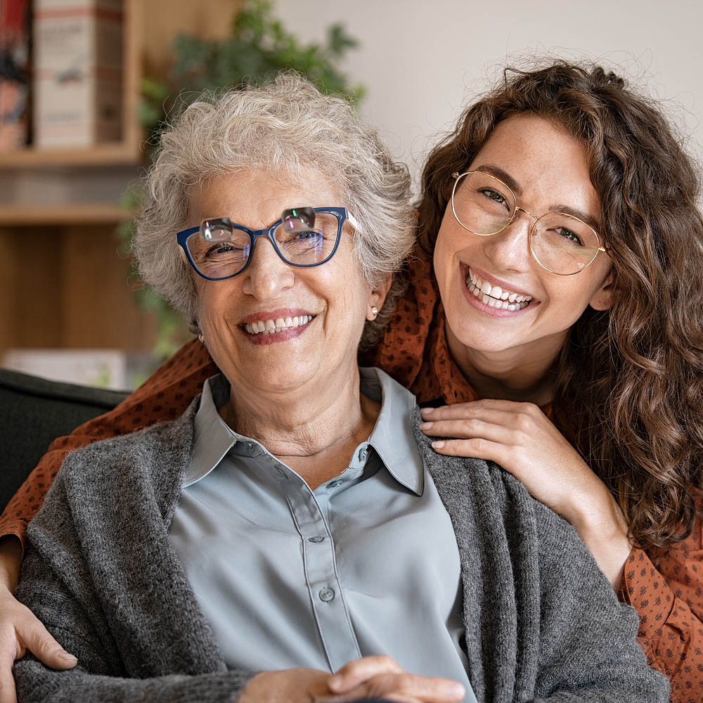 elderly woman wearing low vision glasses with her granddaughter