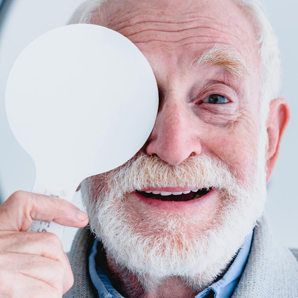 elderly man covering one eye
