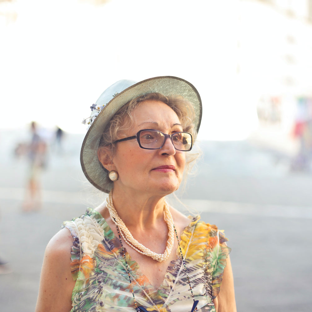 senior woman wearing a hat and eyeglasses