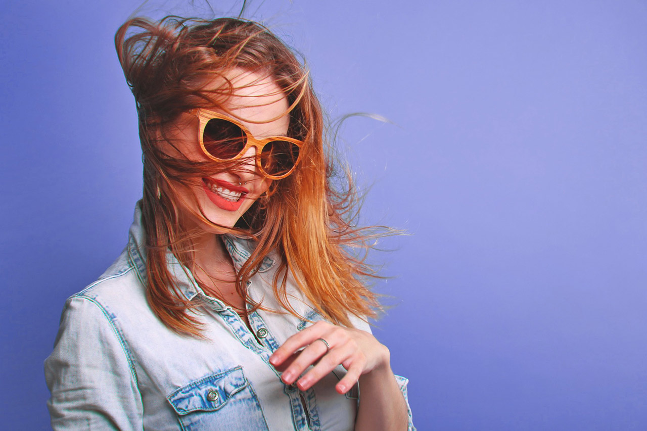 Woman Wearing Sunglasses with Hair Blowing 1280×853