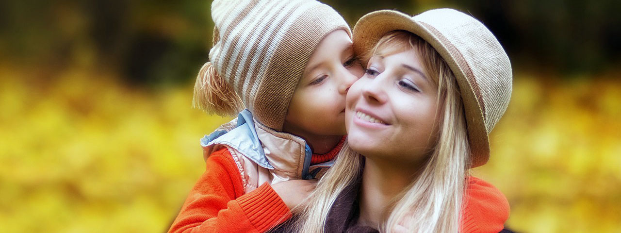 Child Kissing Mother Outdoors 1280×480