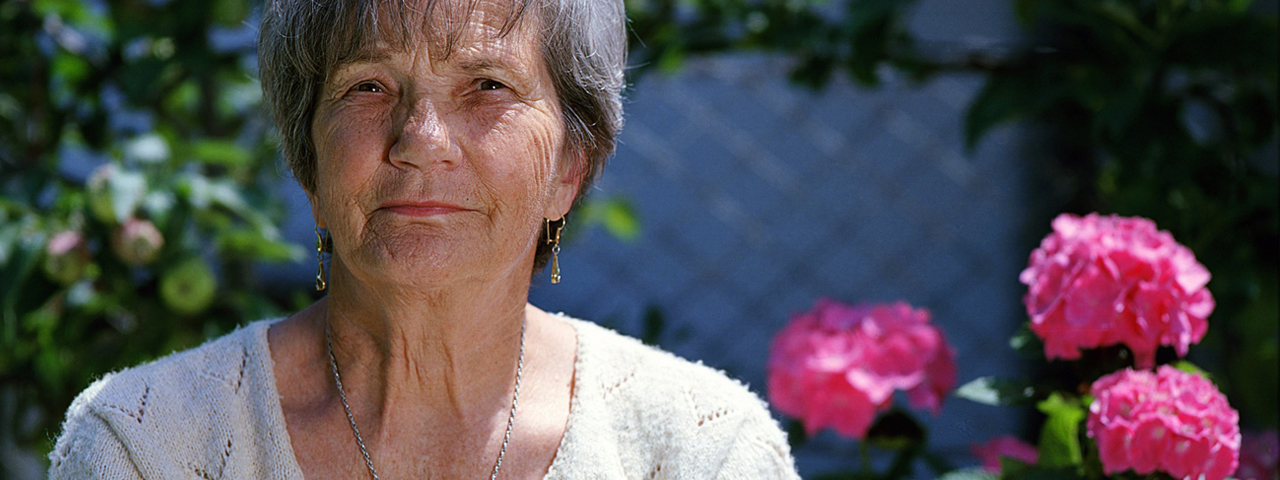 Woman with Low Vision, Pink Flowers in Background