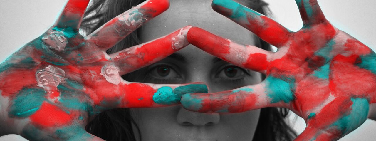 Girl's eyes through colorful hands, image for Ocular Disease Treatment