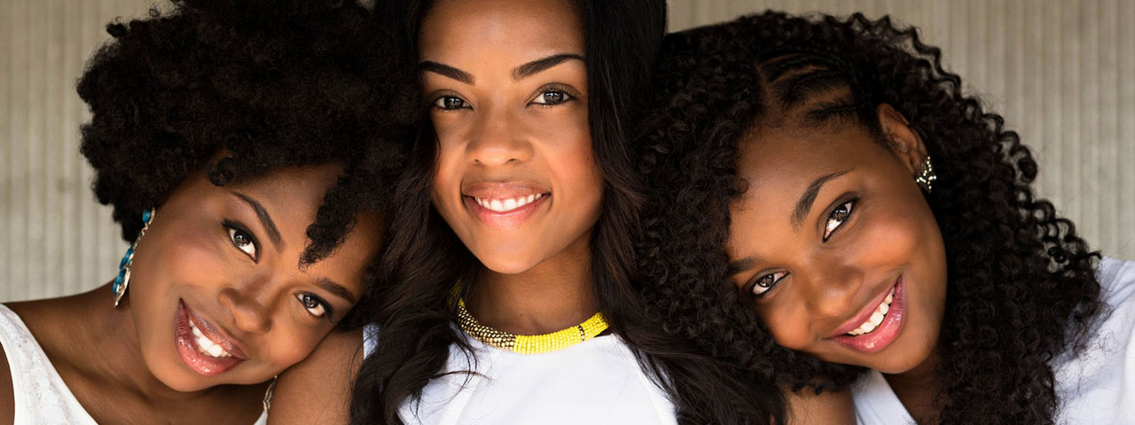 Happy African American Girlfriends. Regular eye exams help detect glaucoma. When was your last eye exam?
