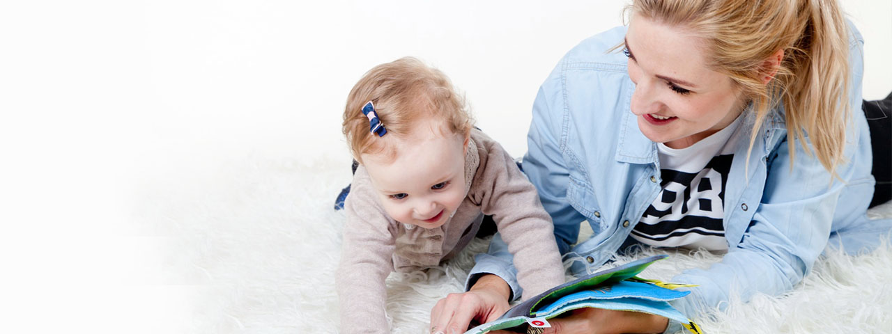 Young Mother Reading to Baby 1280×480