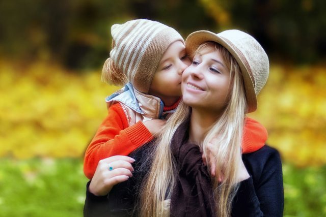 Child Kissing Mother Outdoors 1280×853