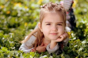 Optometrist, little girl sitting on the grass in Rocky Mount & Roanoke, VA