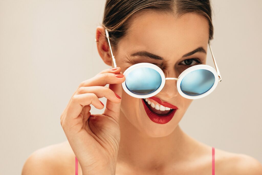 woman in sunglasses smiling