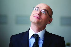 Bald businessman, wearing eyeglasses