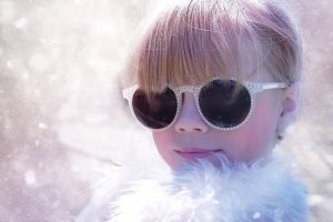 girl wearing sunglasses in the snow
