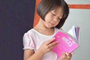 Asian Girl Reading Book, eye doctor, Akron, OH
