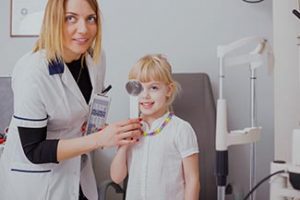 girl checking her vision in doctors office