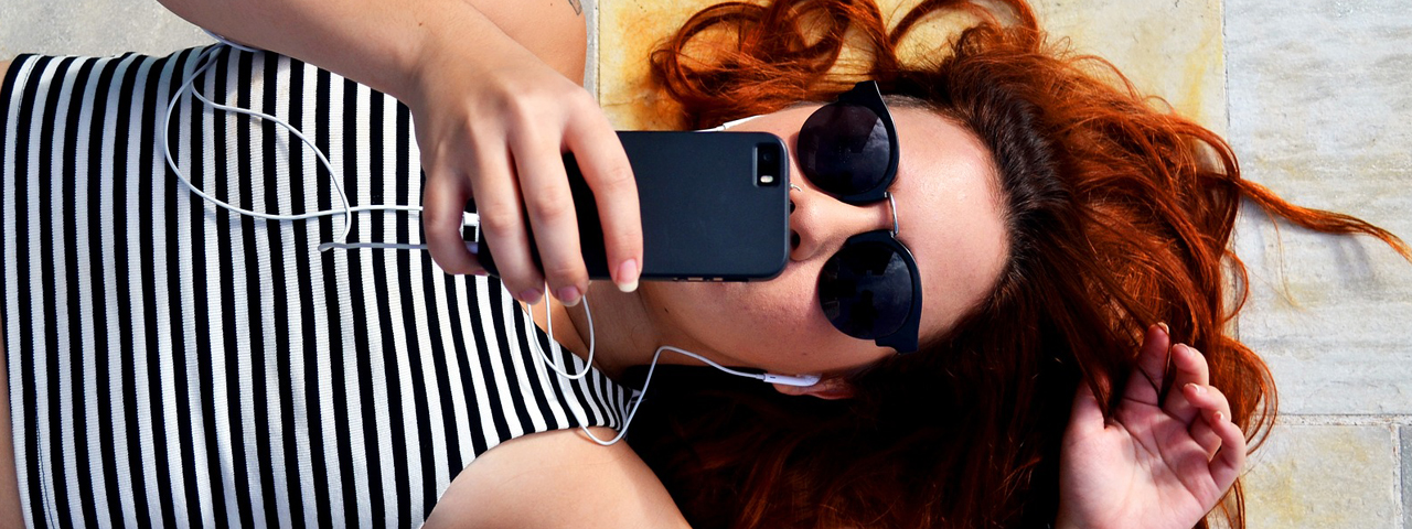 female redhead lying down sunglasses in Garden Grove, CA