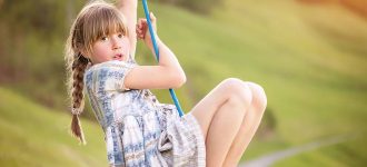 Young girl playing on swing advertising VST (Ortho-K) in Ashburn, VA