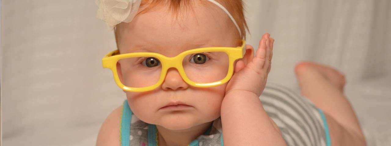 baby girl yellow glasses closeup 1280x480