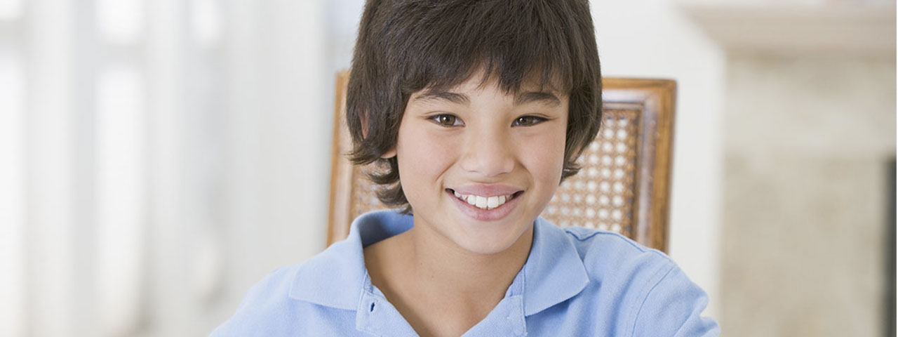 Boy in a blue shirt smiling