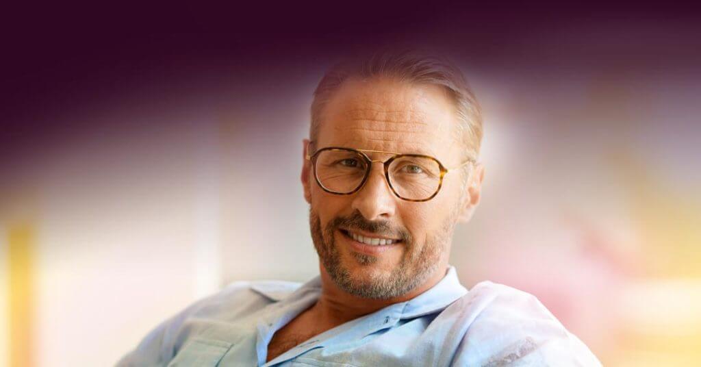 Man wearing round glasses smiling