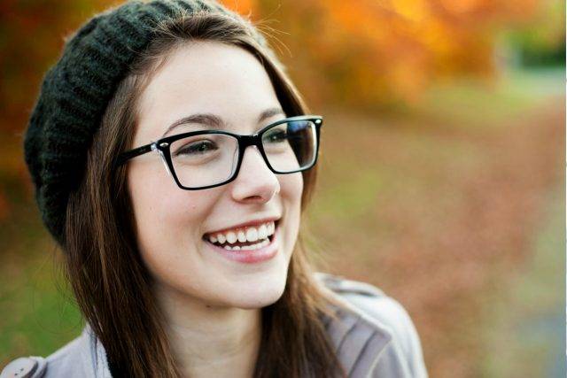Woman wearing eyeglasses, smiling