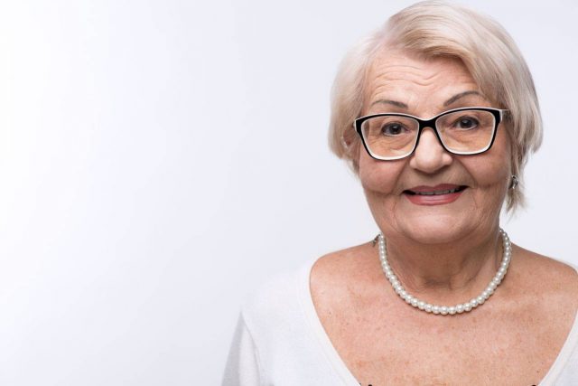 senior woman with glasses for keratoconus treatment with eye doctor