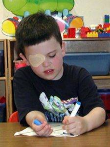 Tampa Florida boy with amblyopia eye patch coloring