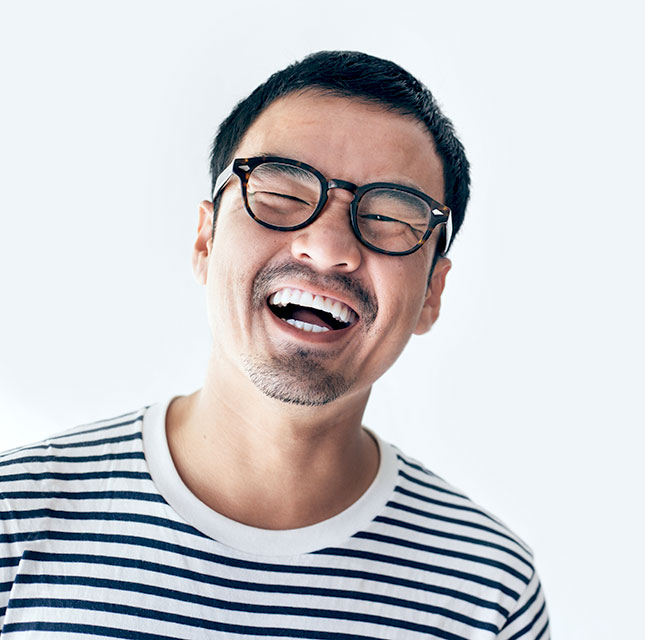 man with glasses laughing