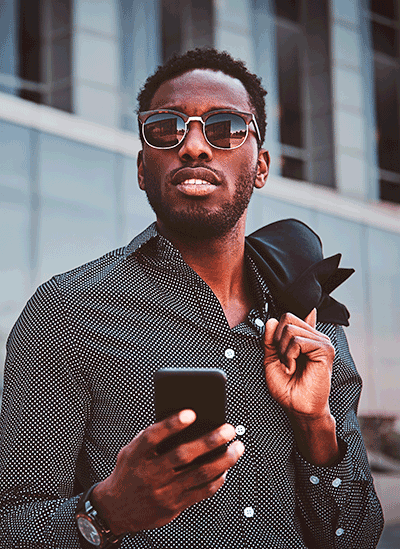 man holding a phone with sunglasses