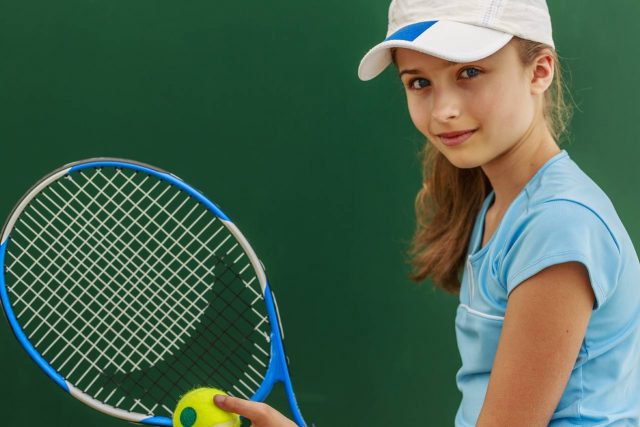 Girl wearing contact lenses, playing tennis