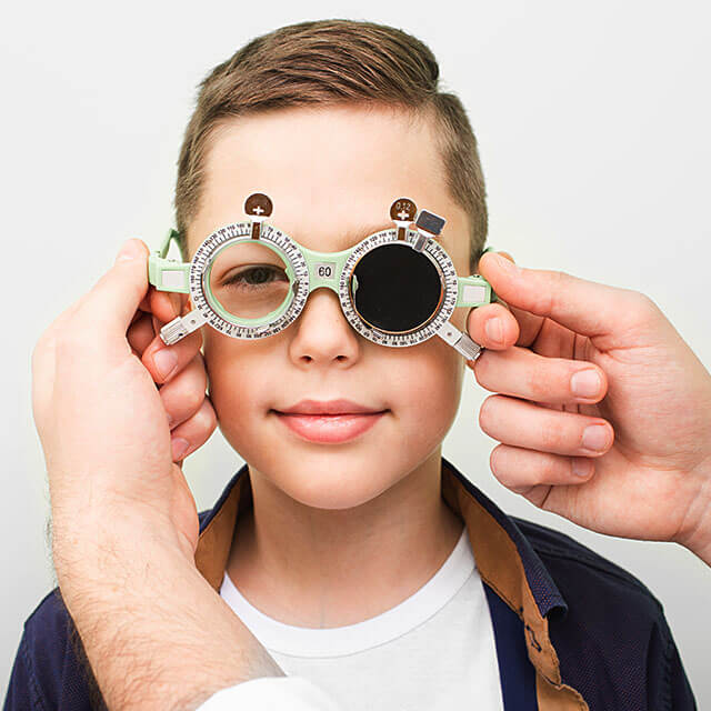 optometrist examining boy 640