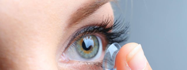 Eye doctor, woman putting on a GP contact lens in Raleigh, Durham, Cary, Fayetteville, Wilmington & Burlington, NC