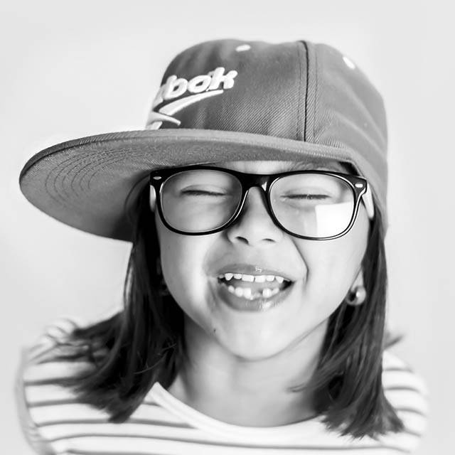 Young girl wearing eye glasses and smiling