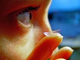 holding contact lens near your eye in Burnsville, MN