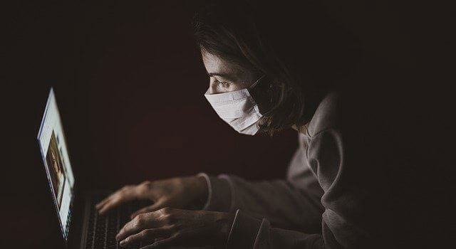 Teen wearing a mask at the computer in Lakeland, Florida