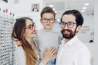 Family With Little Son In The Glasses Store