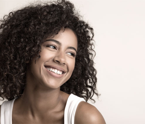 light skinned black girl curls smiling