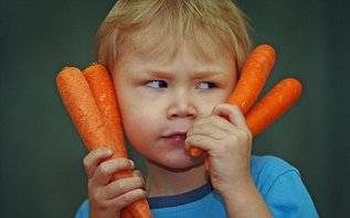 boy holding carrots