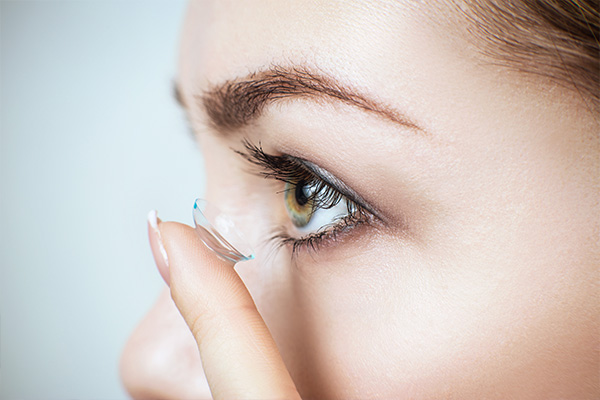 Woman inserting contact lens - Optometrist - Fairfax, VA