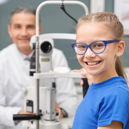 smiling girl having eye exam