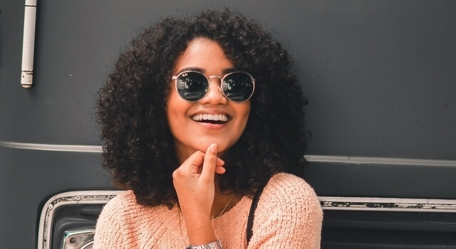 woman wearing sunglasses smiling 640