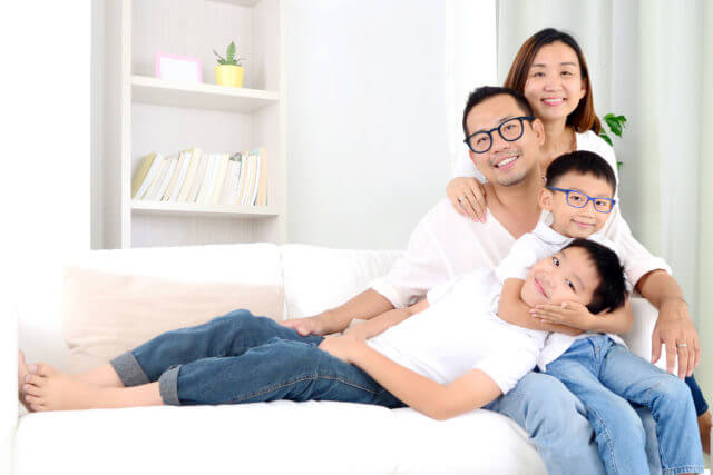asian family sitting on the sofa