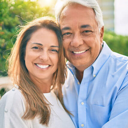 Latina couple smiling outdoors AdobeStock 381038845 Riz Eye Care WP 1499