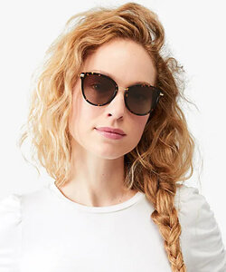 Model wearing Kade Spade sunglasses