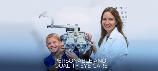 Dr. Ely and young boy in eye exam 