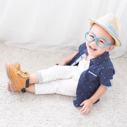 happy little boy wearing blue rimmed eyeglasses 640