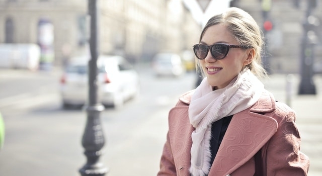 woman smiling wearing sunglasses in winter 640×350