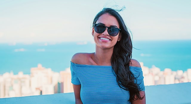 happy woman wearing sunglasses 640x350