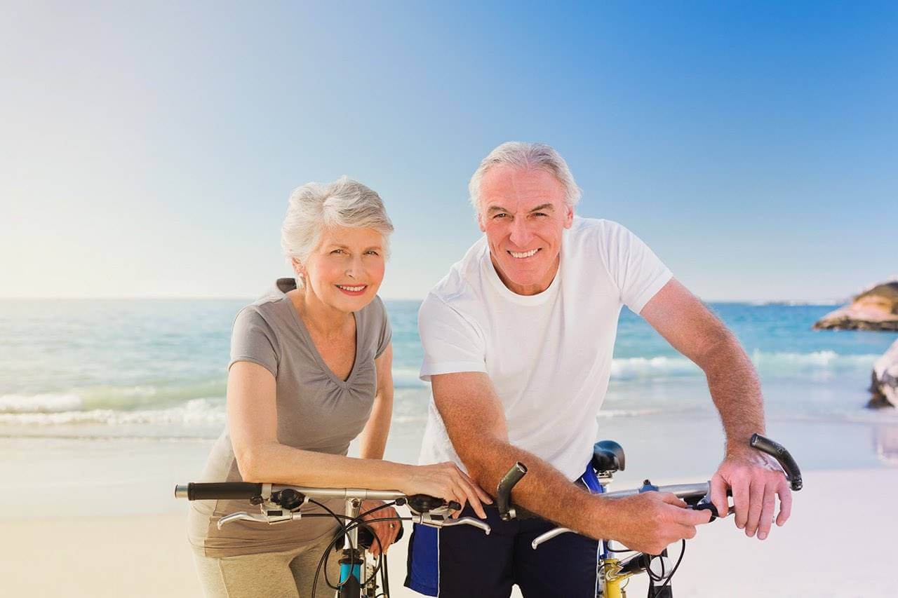 Senior couple beach bicycle 1280×853